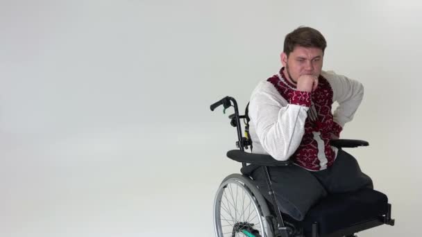 Young Handsome Wheelchair Sits White Background Place Text Experiencing Suffering — Vídeo de stock