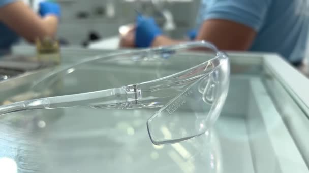 Close Protective Goggles Dentistry Lies Transparent Glass Bedside Table Background — Video