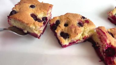 Woman baker is putting a piece of pie with jelly fresh berries on a white plate. . High quality 4k footage