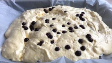 The process of making a berry roll. The confectioner sprinkles powdered sugar on the berries that lie on the dough. High quality 4k footage