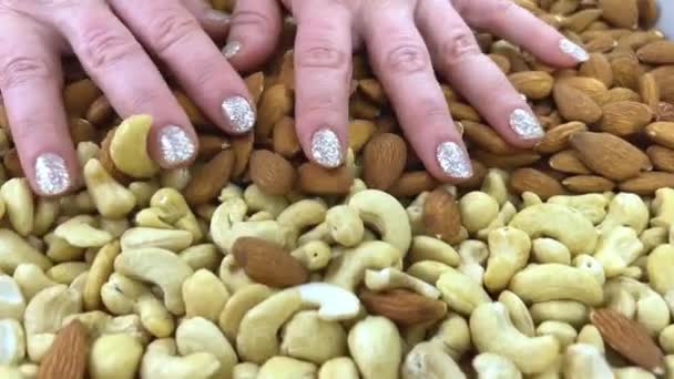 Hand Full Mixed Nuts More Nuts Background Black Table Selective — Stockvideo