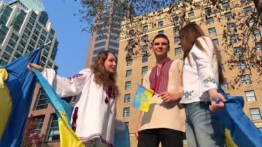 Teenagers celebrating Independence Flag Day. Constitution day. Ukrainian child girl in embroidered shirt vyshyvanka with yellow and blue flag of Ukraineflag symbols of Ukraine. Kyiv, Kiev day