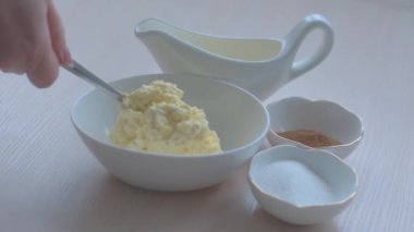 pour curd mass into an oval plate, cottage cheese, egg and sugar with vanilla for filling strudel pies and napkins, cheesecakes and cheesecakes