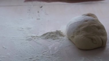 rolling pin downloaded dough for pies or pizza close-up on Light table how much is first put on dough then it is removed cooking at home in restaurants handmade pastry cooking space for text and ad