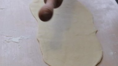 rolling pin downloaded dough for pies or pizza close-up on Light table how much is first put on dough it is removed cooking at home in restaurants handmade pastry cooking space for text and ad