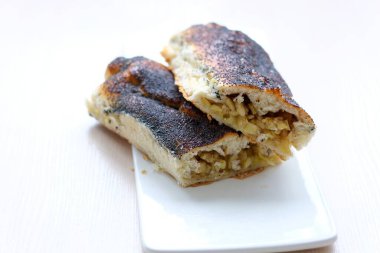 strudel with apples sprinkled with poppy seeds on white flat plate and light background no other ingredients clean space for your text delicious food cooking homemade baking products healthy food