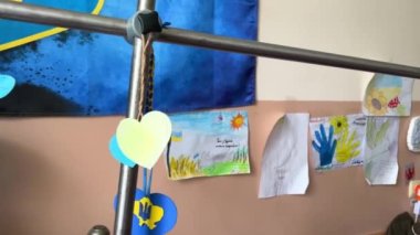  in hospital of wounded military soldiers the flag of Ukraine stained with blood hangs on wall war in Ukraine Russia is terrorist drawings of children on wall for defenders of motherland ukraine war