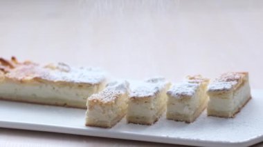 Cottage cheese strudel with icing sugar ingredients curd strudel Curd cheese strudel made with quark cheese. Bavarian dessert Slice of fresh baked homemade strudel collage cheese sugar powder