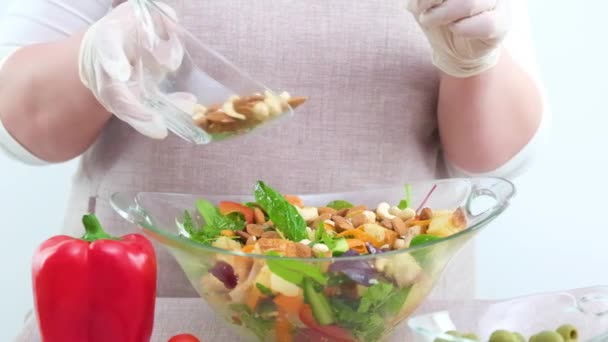 Woman Slowly Adding Nuts Cashew Salad Almonds Hazelnuts Woman Gloves — Stockvideo