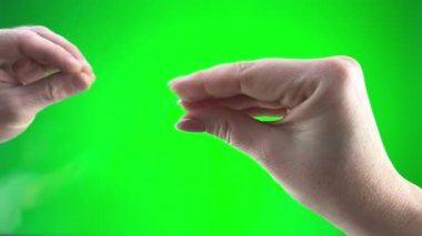 two hands play on green background chromakey Man and woman they seem to be birds fit each other collarbone and kiss funny video Love tenderness closeness mans hand absorbs