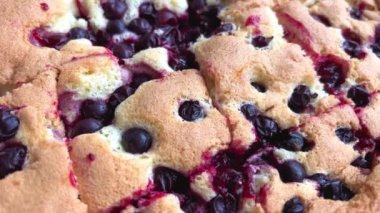 close-up pie with cherries currants or blueberries airy dough cut into pieces but not yet arranged on plate homemade pastries cooking