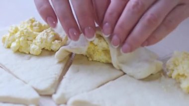 Female Hands Rolling Dough into Rolls Baking Process Making Croissant Selected Focus Concept for Bakery process of cooking and baking croissants sprinkle sick with cinnamon curd handmade breakfast 
