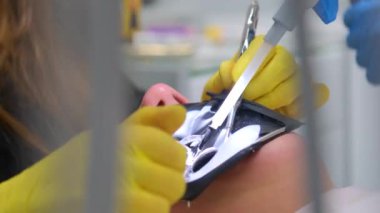 Modern dental equipment Medium shot of female dentist mask gloves using dental microscope to examine patients teeth doctor patient assistant dental treatment prosthetics canals fillings false teeth