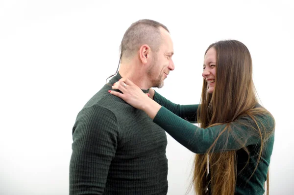 comic photo woman is angry at man strangling him with both hands behind neck smiling and closing eyes at man behind pigtail white background relationship anger game priority in family daughter father