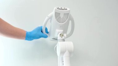 turn on the process doctor in glove presses the button the device goes up Beyond Poluse advanced whitening system with dental UV laser whitening Tretmant light laser and fluoride Ukraine 2023