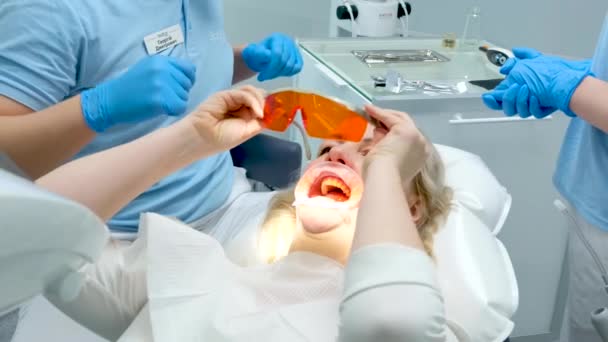 Dental Clinic Doctor Gives Red Orange Goggles Work Photopolymer Lamp — Video