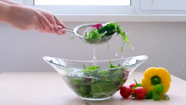 Woman Washes Salad Glass Dish Using Sieve Lifts Splashing Water — Stockvideo