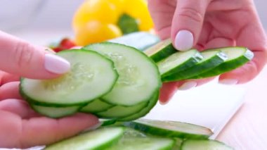 in female hands cucumber cut vegetables food beauty face mask thinly cut vegetable