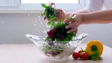 Super Slow Motion Shot of Flying Cuts of Colorful Vegetables and Water Drops Close up of hands people washing vegetables by tap water at the sink in the kitchen to clean ingredient prepare fresh salad