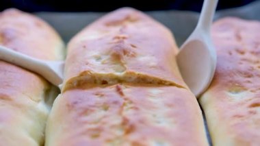 two wooden spoons raise a delicious apple pie hot steam comes out pastries from the oven just cooked for children grandchildren restaurant pastries delicious serving a lot of toppings apple strudel