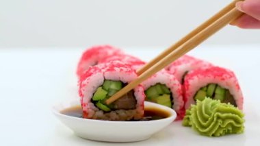 California Maki Sushi with Masago Roll made of Crab Meat, Avocado, Cucumber inside. Masago smelt roe outside. High quality photo