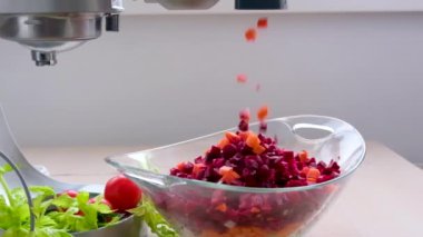 food processor cut cubes cut into small squares carrots and beets in food processor slow motion video falling into a glass plate cooking ukrainian borscht borsch borscht olivier vinaigrette