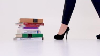 studio on white background knowledge concept study graduate medical university college technical school Tired of studying to know science Cheers learned woman in beautiful high-heeled shoes stands