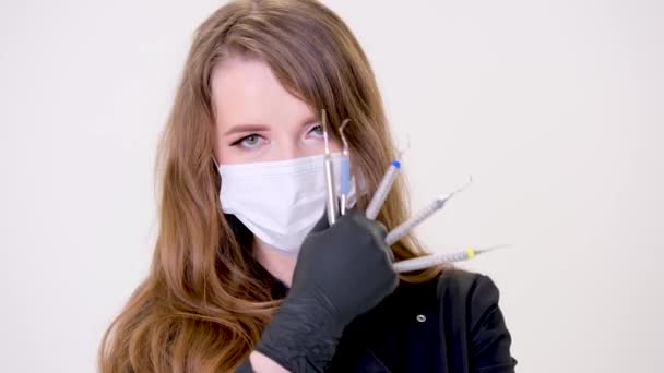 Beautiful Woman Dentist Black Suit White Mask Flowing Hair Holds — Vídeo de Stock