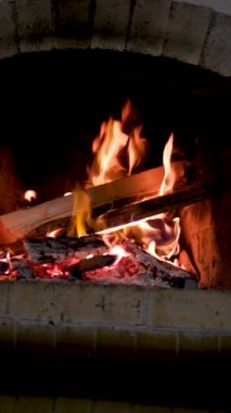 add tossing logs in fire burning flames close-up in the fireplace flames heat heat to warm up heat no electricity ancient house of life around the fire cook food on the fire