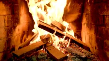 Bright red and orange embers of bonfire at night. Beautiful fiery natural background. Flaming Charcoal In BBQ Grill Pit Isolated On Black Background. Slow motion. High quality 4k footage