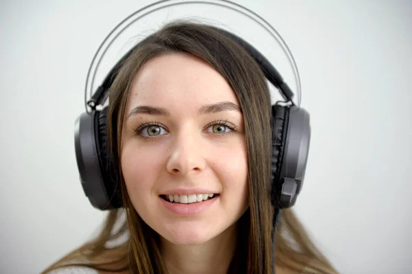 face of a young girl in headphones luminous big headphones professional music sound writer teenager student student online conference training english language courses listening comprehension