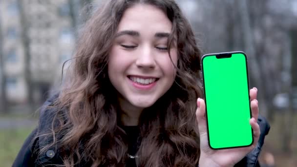Young Girl Points Phone Empty Space Text Green Screen Chromakey — Αρχείο Βίντεο