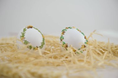 Easter eggs are decorated in variety of ways using ordinary needle of multi-colored threads of ribbons you can turn ordinary eggshell into souvenir miniature drill Easter from place for text handmade