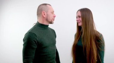 comic photo woman is angry at man strangling him with both hands behind neck smiling and closing eyes at man behind pigtail white background relationship anger game priority in family daughter father