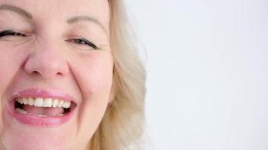 Portrait of happy woman smiling and standing isolated on white background girl with perfect smile looking right Beautiful female smile after teeth whitening procedure. Dental care. Dentistry concept.