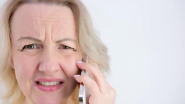 white background close-up woman screaming with her mouth open holding the phone raised hands and spread her fingers to the sides joy dissatisfaction success victory defeat good news bad news