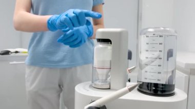 Device for deep cleaning of teeth from tartar Cleaning stones plaque newest apparatus Dentistry new inventions Airflow doctor in blue gloves turns on apparatus Ukraine Vinnitsa Salon Space 26.12.2022