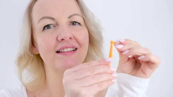 Kobieta Demonstruje Nową Pomarańczową Szczoteczkę Zębów Zdejmuje Nakrętkę Specjalnego Urządzenia — Wideo stockowe