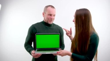 rear view of businessman looking at laptop with green screen in office. man showing laptop chroma key High quality photo