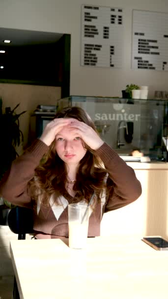 亚洲女青年在咖啡店里喝冰镇咖啡时的衣物 — 图库视频影像