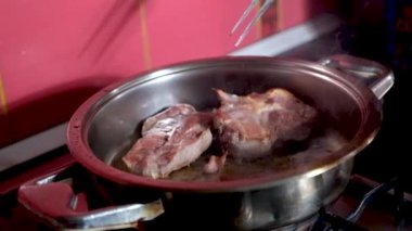 barbecue cutlets look very tasty cooked for a hamburger on a hot open fire on the grill turns over with a spatula after each turn the fire flares up and creates slow motion video for any restaurant.