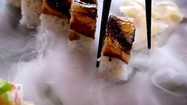 Closeup Black Chinese Chopsticks Take Eel Sushi Plate Cold Dry — Stok Video