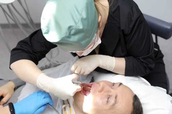 remove teeth Dentist doctor works with a patient close-up. High quality photo