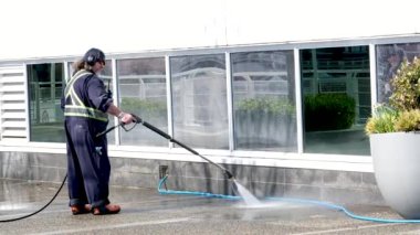 Temizlik şirketi hademesi özel üniformalar asfaltı Kanada 'da bir akarsu akıntısıyla temizlemek sokak temizliği gezintileri için yer Kanada Vancouver 2023 ofis binası