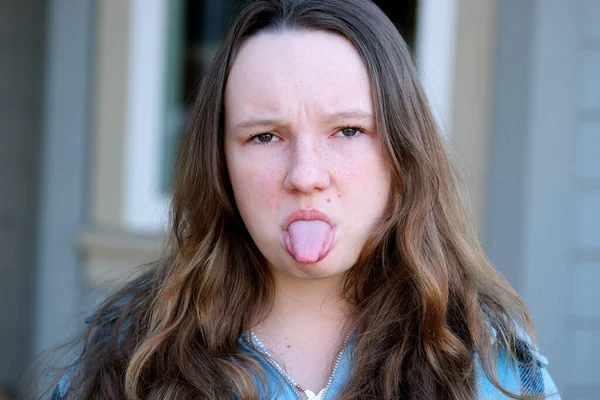 Young Girl Angry Teenager Stuck Out Her Tongue Looks Frame — Stock Photo, Image