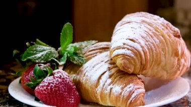 Fırında kruvasan ve taze bir çilek tabağı. - Evet. Yüksek kalite 4k görüntü