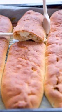 İki ahşap kaşık, elmalı turtayı kaldırıyor fırından yeni pişmiş hamur işleri çıkıyor çocuklar için, torunlar için, restoran hamur işleri lezzetli. 