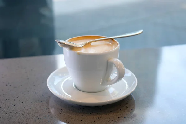 Woman hand pouring sugar and stirring coffee with spoon, coffee time. Stirring latte coffee with a spoon. High quality 4k footage