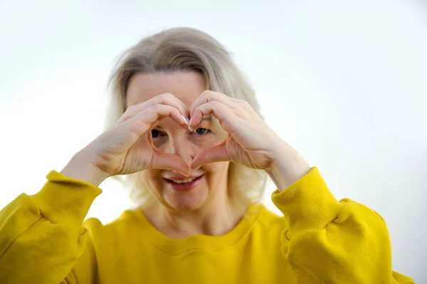 woman making her hands in heart shape, heart health insurance, social responsibility, donation charity, world heart day, appreciation, world mental health day, stop hate concept