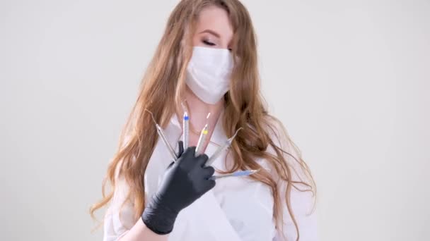 Beautiful Woman Dentist Black Suit White Mask Flowing Hair Holds — Stockvideo